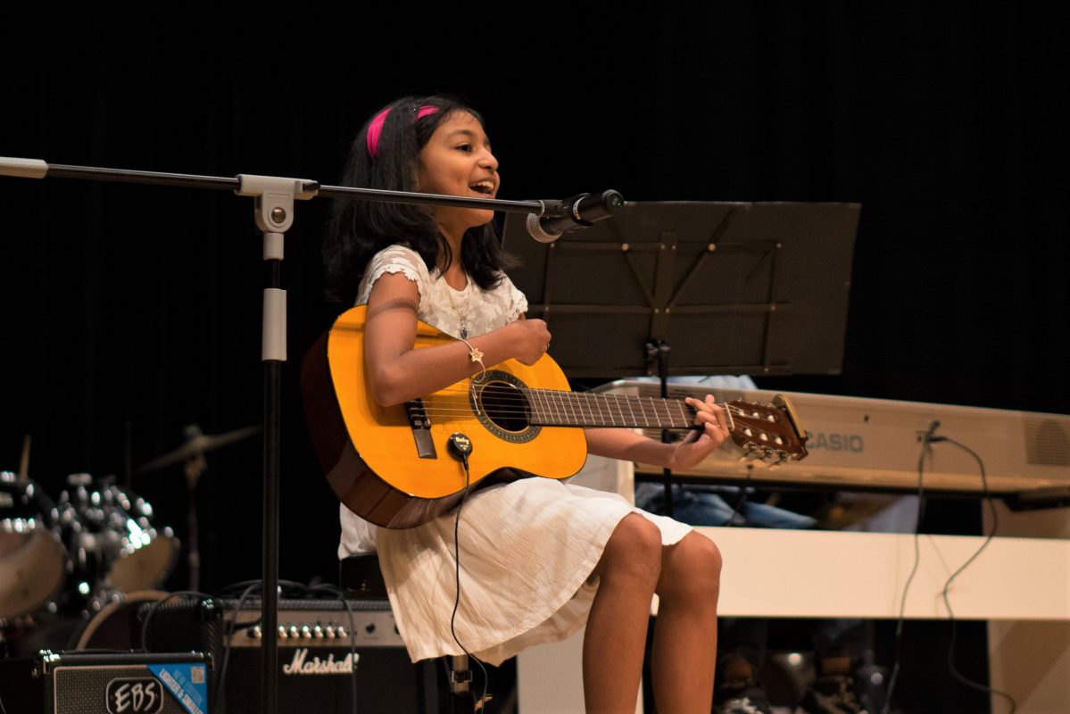 Fine Momentum music class student performing on stage