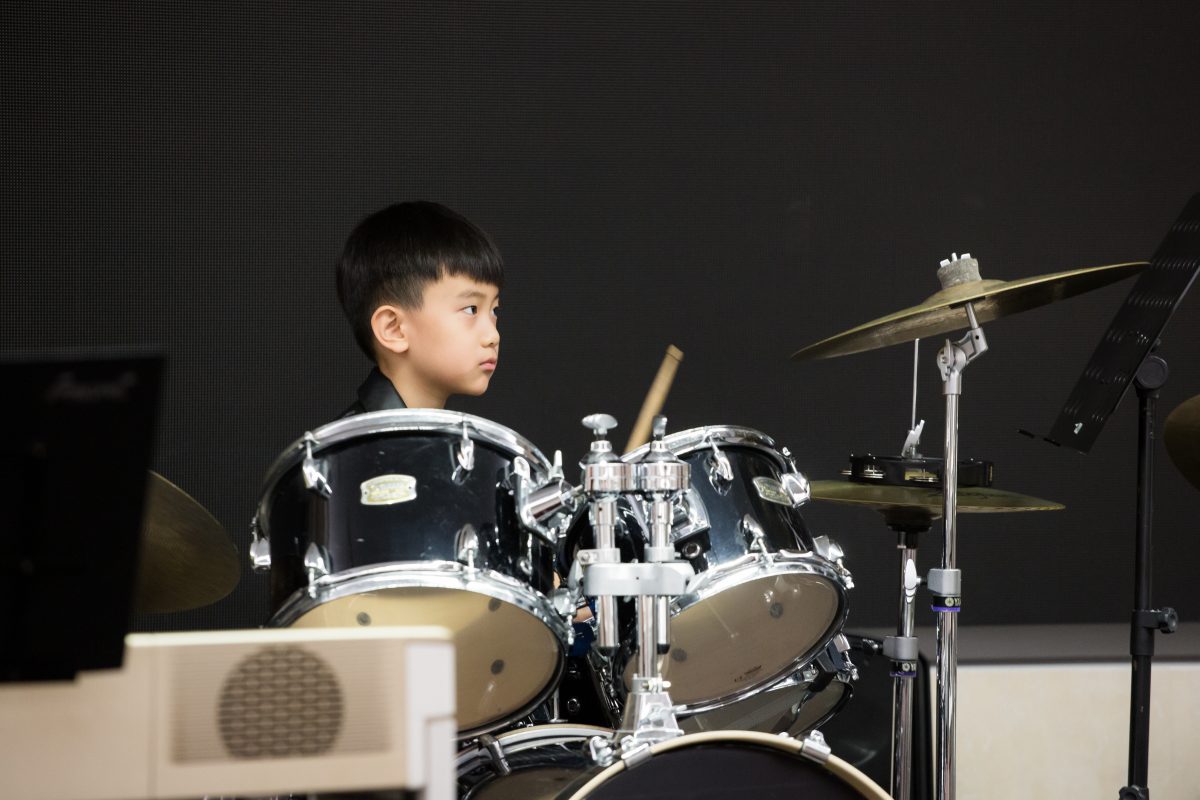 Fine momentum music lesson student performing the drums