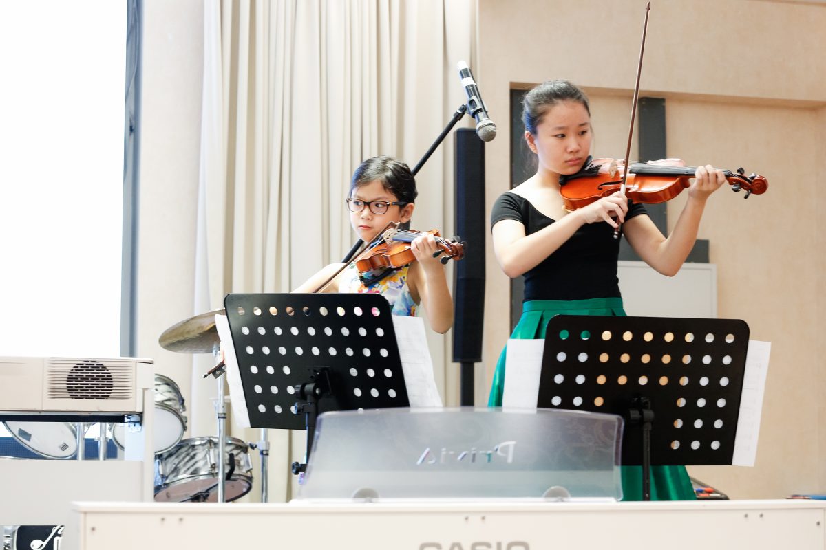 Fine momentum music lesson student performing the violin
