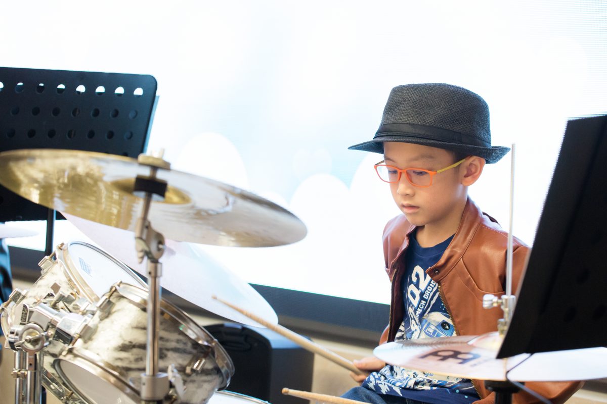 Fine momentum music lesson student performing the drums
