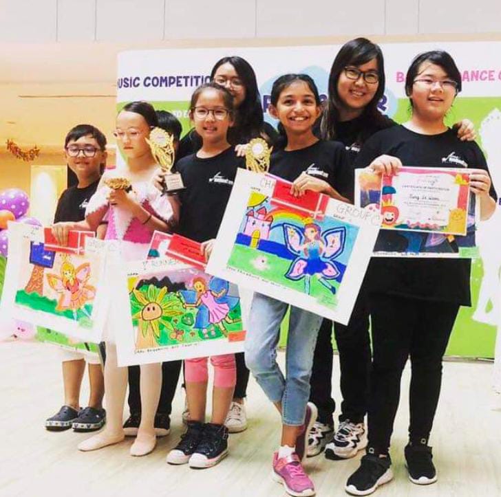 Our art students at Fine momentum showcasing their artwork with instructor at art competition