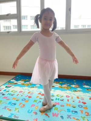 Fine momentum online ballet lesson student showcasing ballet pose