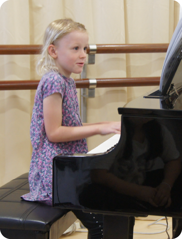Fine momentum piano lesson student playing the piano